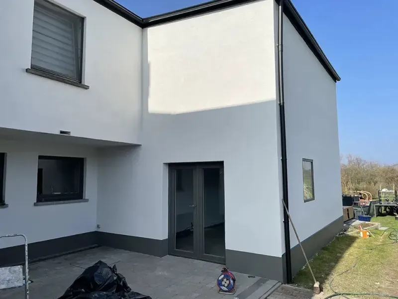 Façade isolée par l'extérieur avec panneaux et enduit à Bruxelles, Bati Belgium Group
